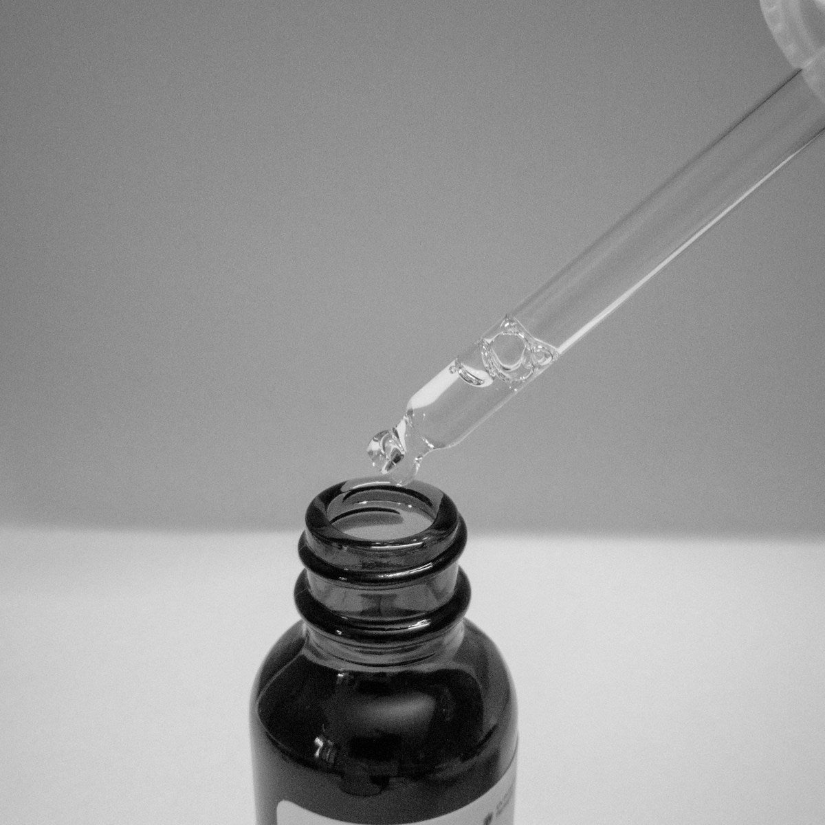 Skincare dropper bottle, minimal styling